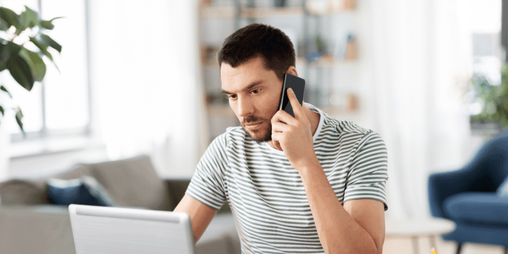 Ghosting from your gay partner is stressful as shown by this photograph of a man holding a phone looking heartbroken.