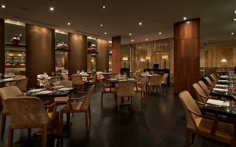 Interior of Rasika in Penn Quarter, featuring an upscale modern dining room with warm lighting and neatly arranged tables.