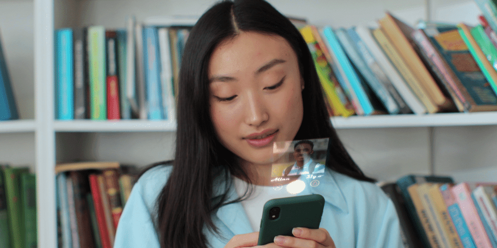An Asian woman looks at her phone searching through a dating app.